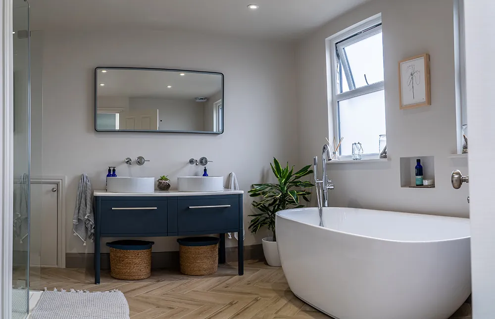 Loft bathroom with a double vanity and a freestanding bath
