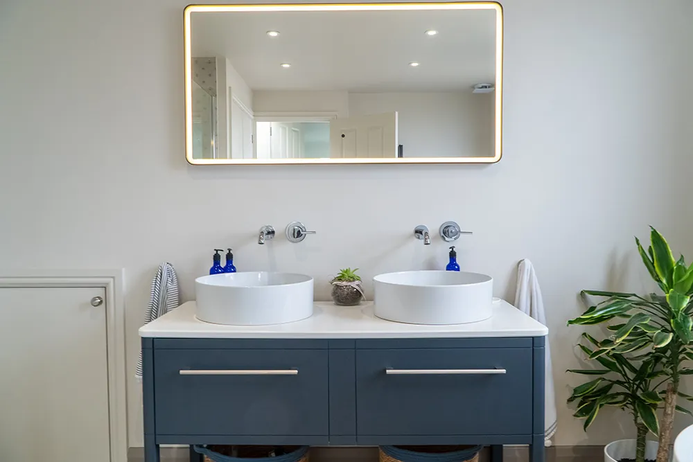 Double basin vanity unit with an illuminated mirror