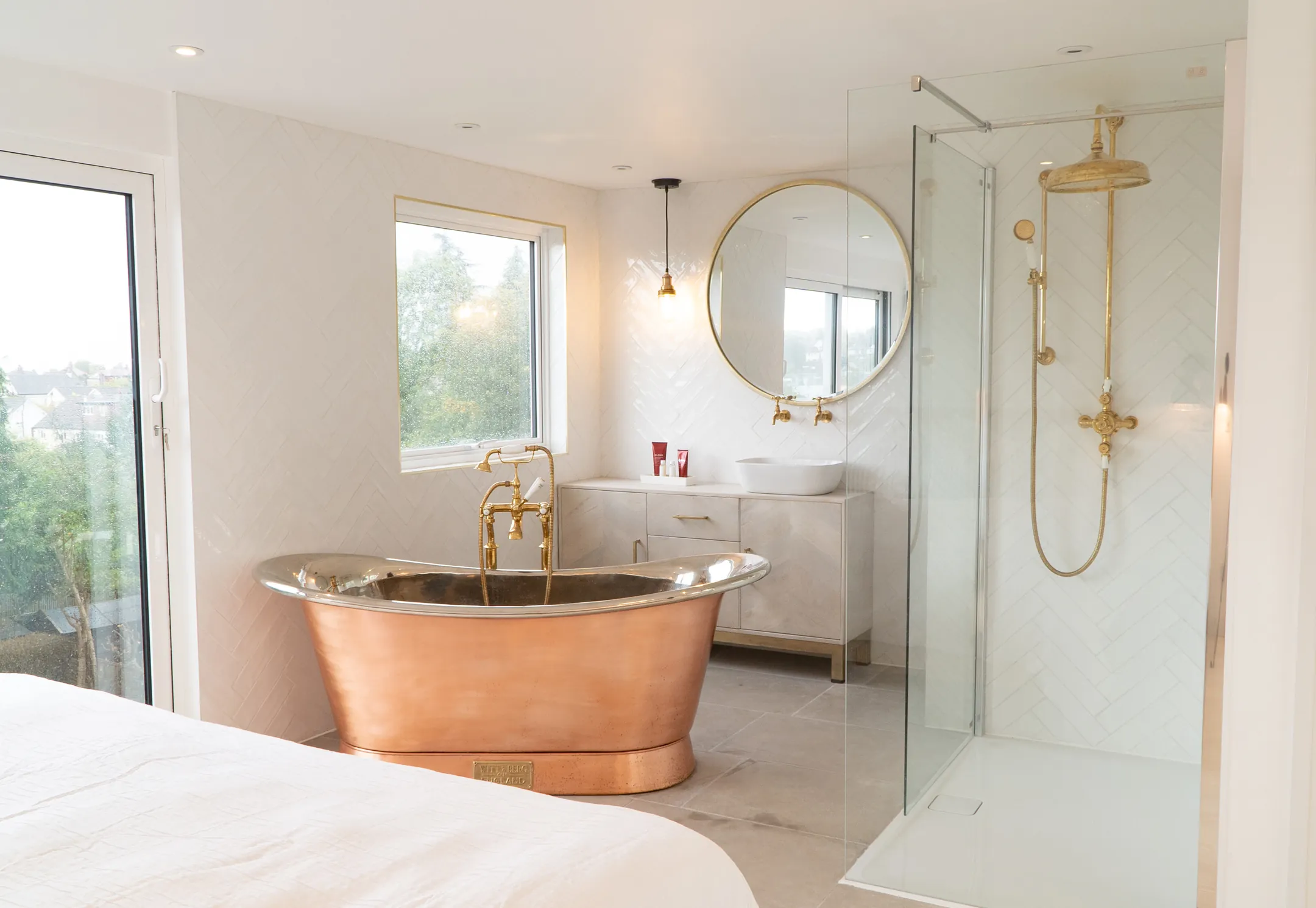 Loft conversion en-suite with a copper roll-top bath and a walk-in shower